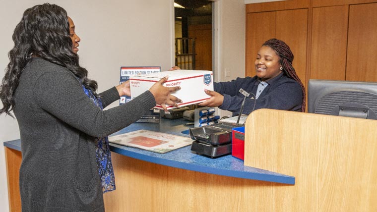 USPS employee inside a retail USPS Post Office.