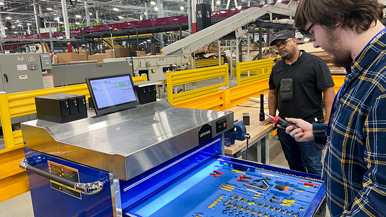 Two USPS Maintenance mechanics looking at a large toolbox